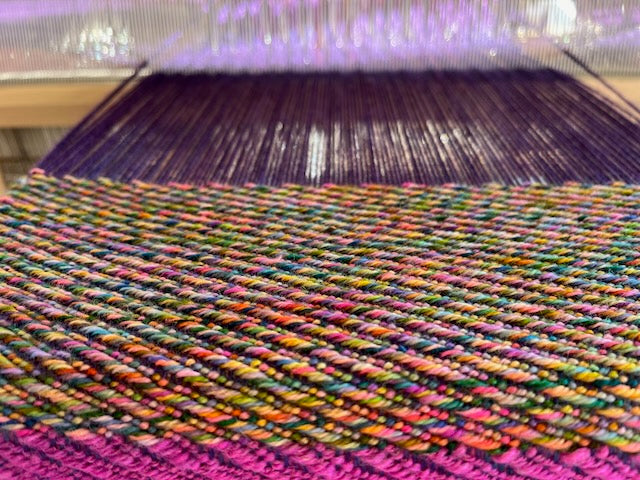 Handwoven scarf on a weaving loom
